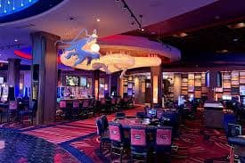 Live poker hand in progress with dealer and players